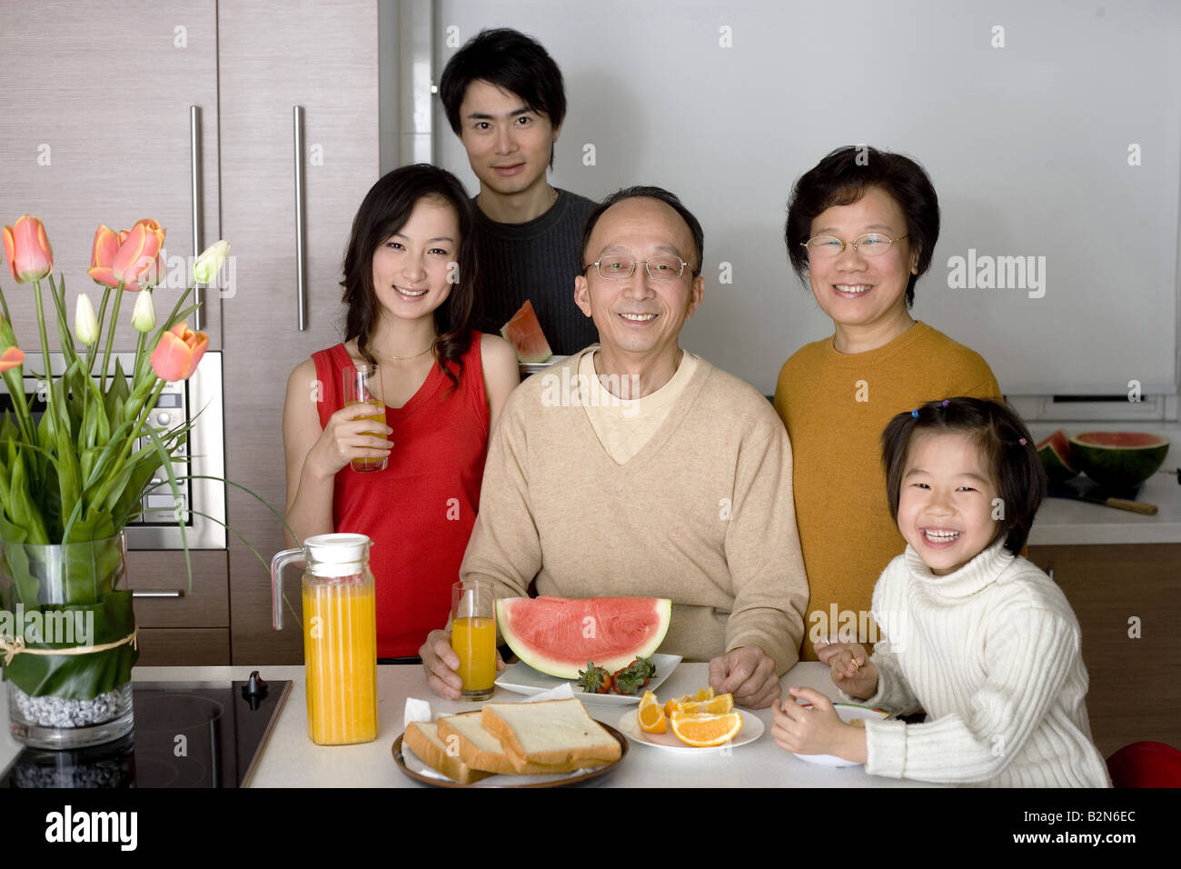 Portrait of a family gathered for breakfast in the kitchen Stock Photo