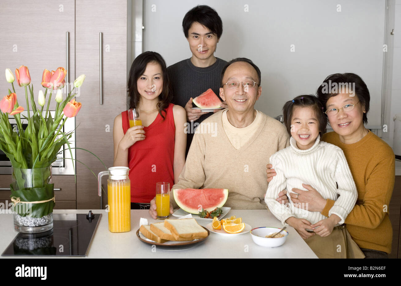 Portrait of a family gathered for breakfast in the kitchen Stock Photo