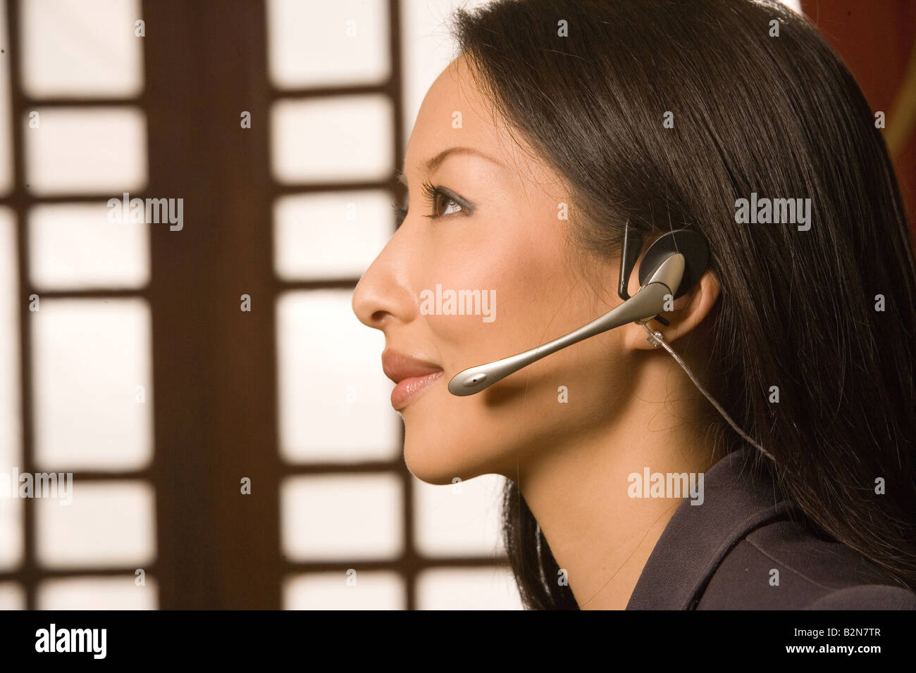 Close-up of a female customer service representative wearing a headset ...