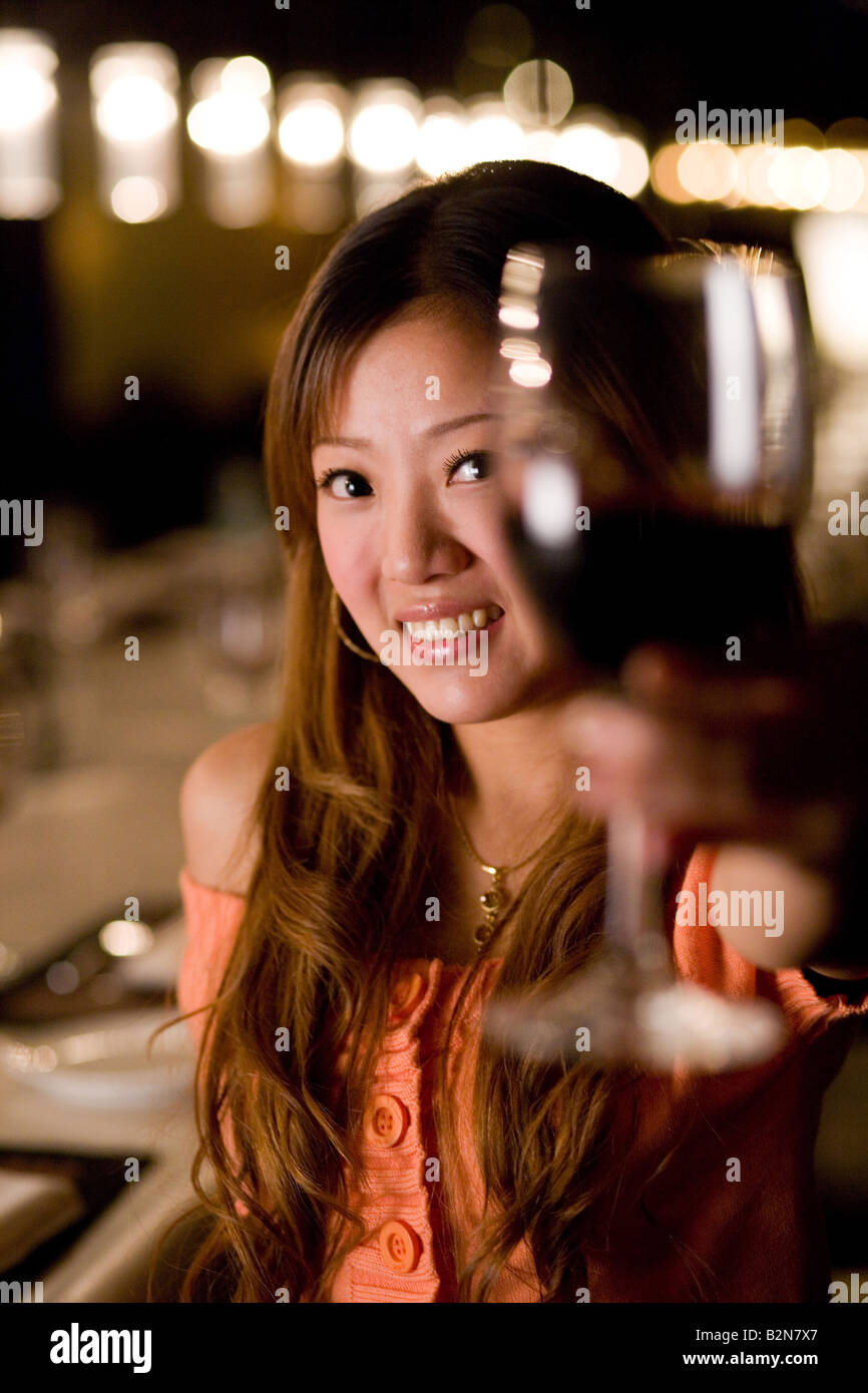 Portrait of a businesswoman holding a glass of wine and smiling Stock ...