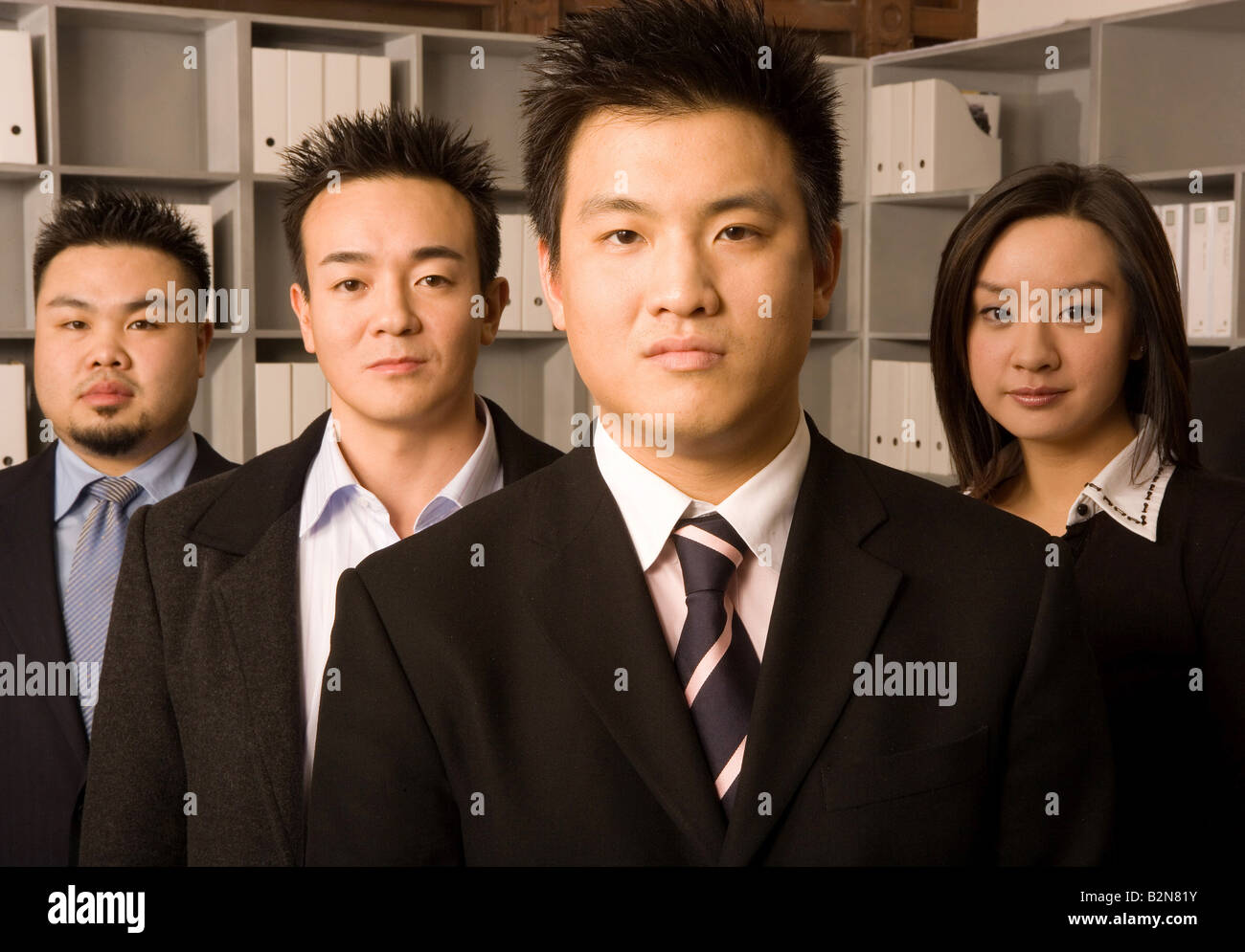 Portrait of four business executives standing in an office Stock Photo ...
