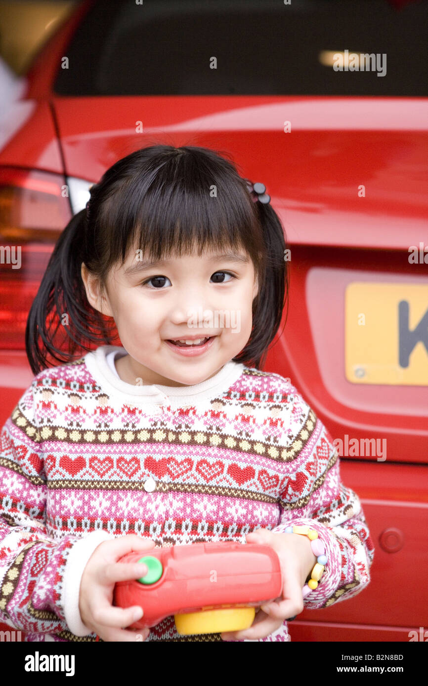 Portrait of a girl holding a toy camera and smiling Stock Photo