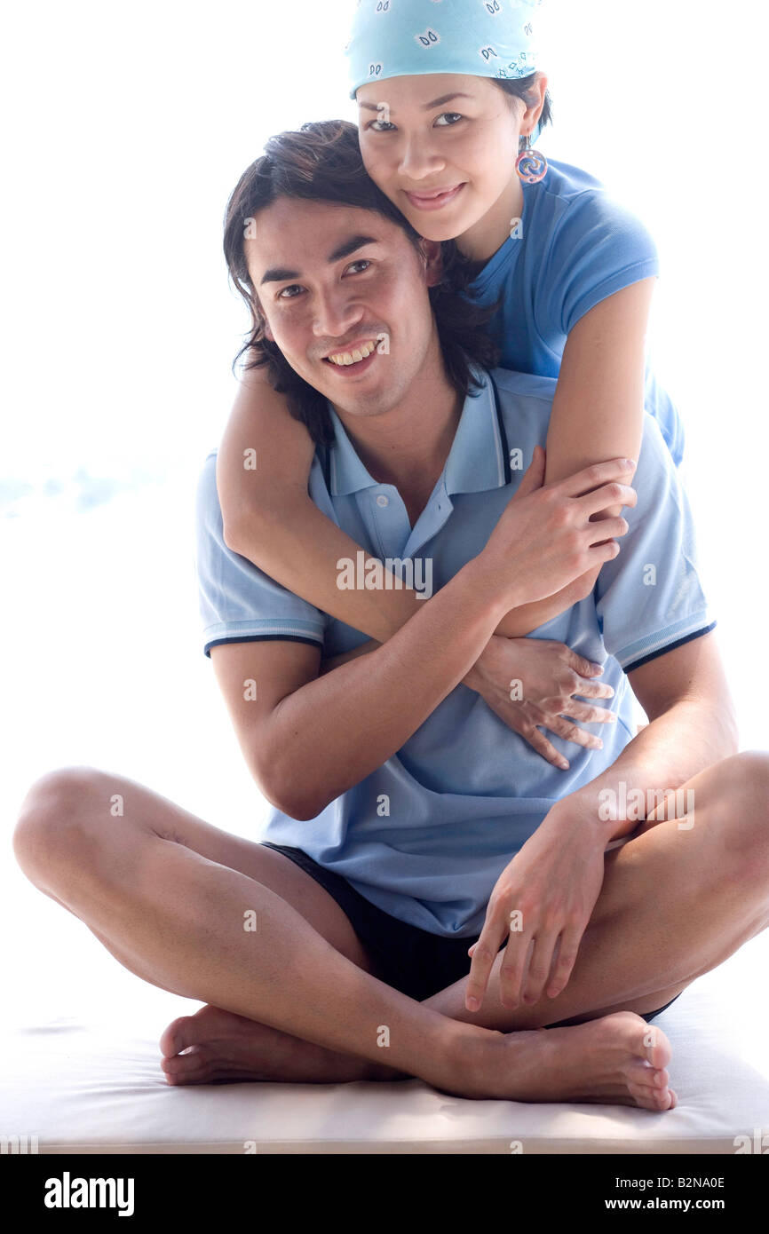 Young woman embracing a young man from behind Stock Photo - Alamy