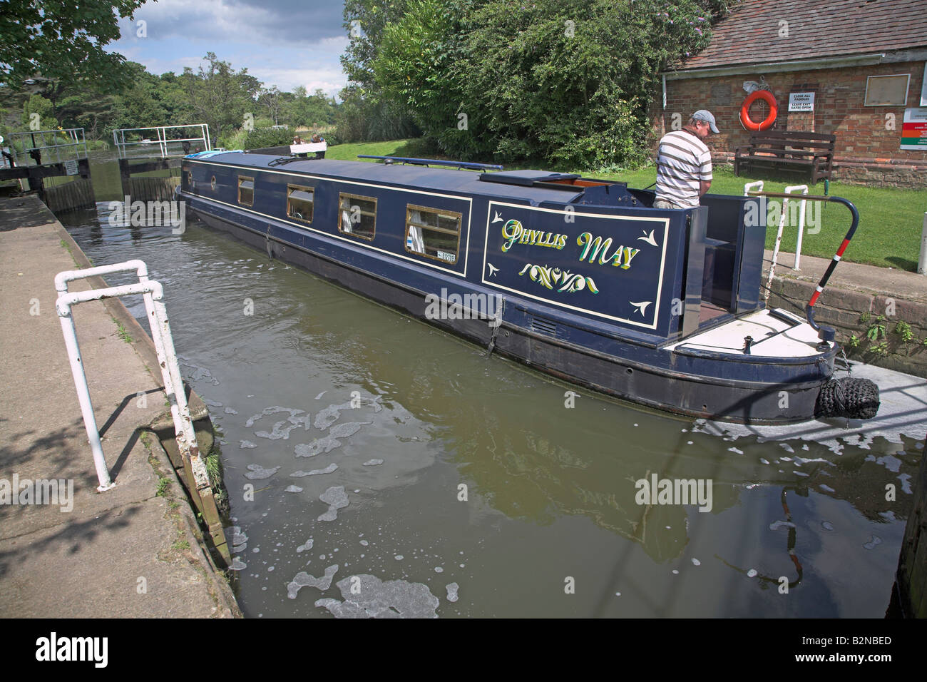 Navigating narrow boat through a lock River Avon, Fladbury