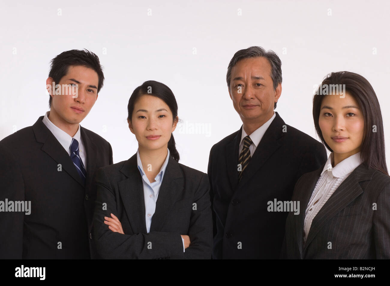 Portrait of two businessmen with two businesswomen standing side by ...