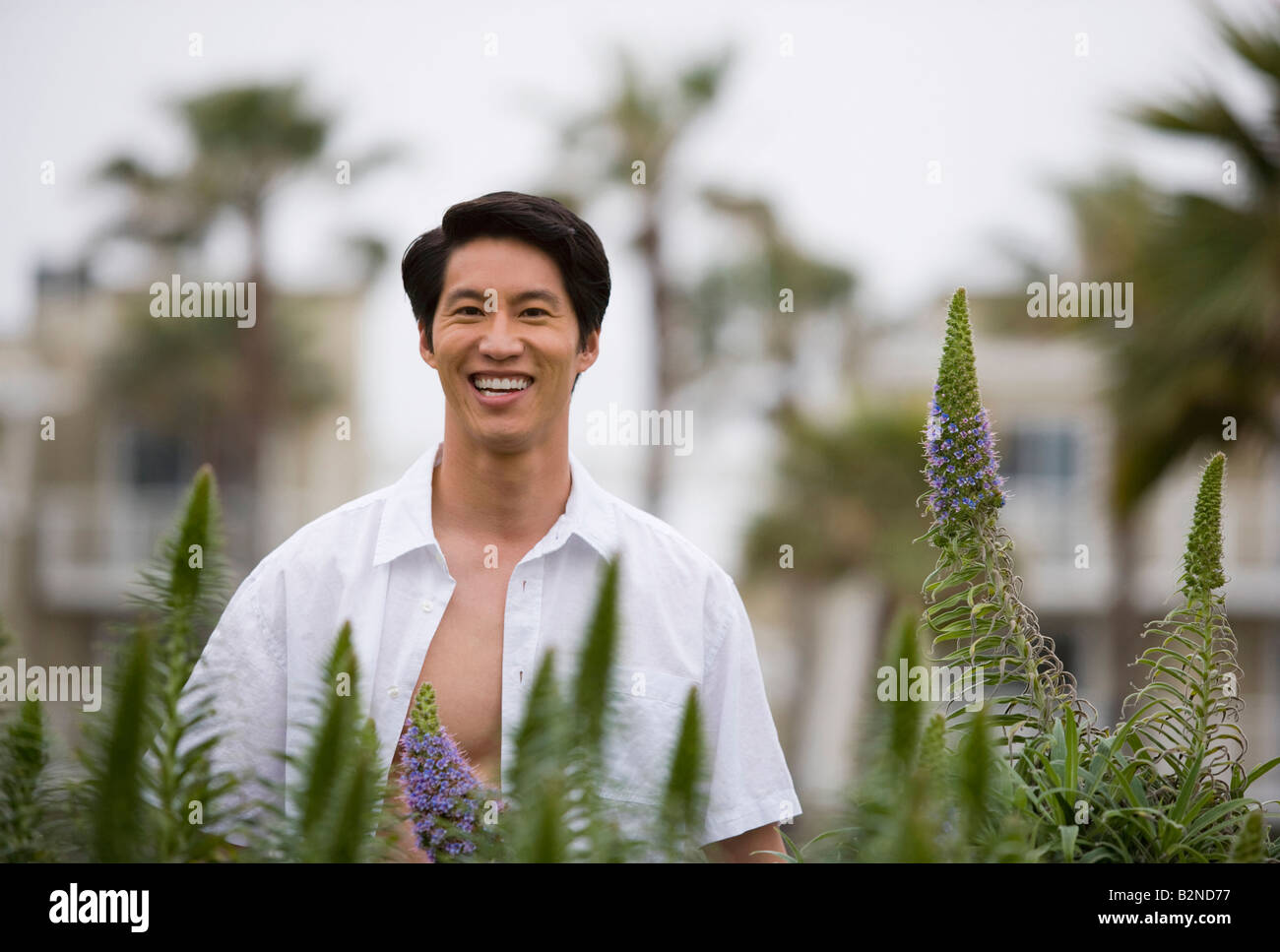 Portrait of a young man standing in a park and smiling, Huntington Beach, California, USA Stock Photo