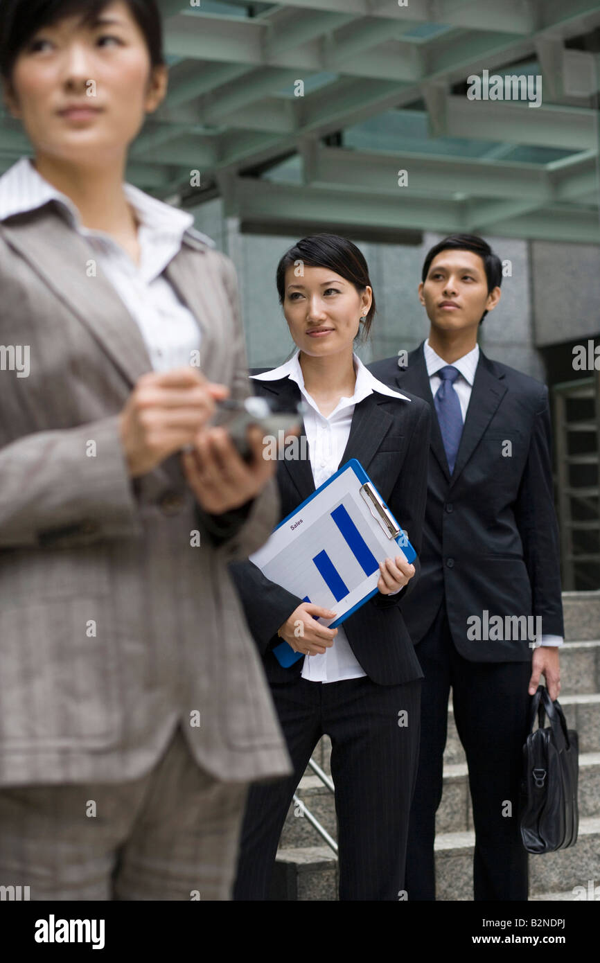 Three business executives standing outside an office Stock Photo - Alamy
