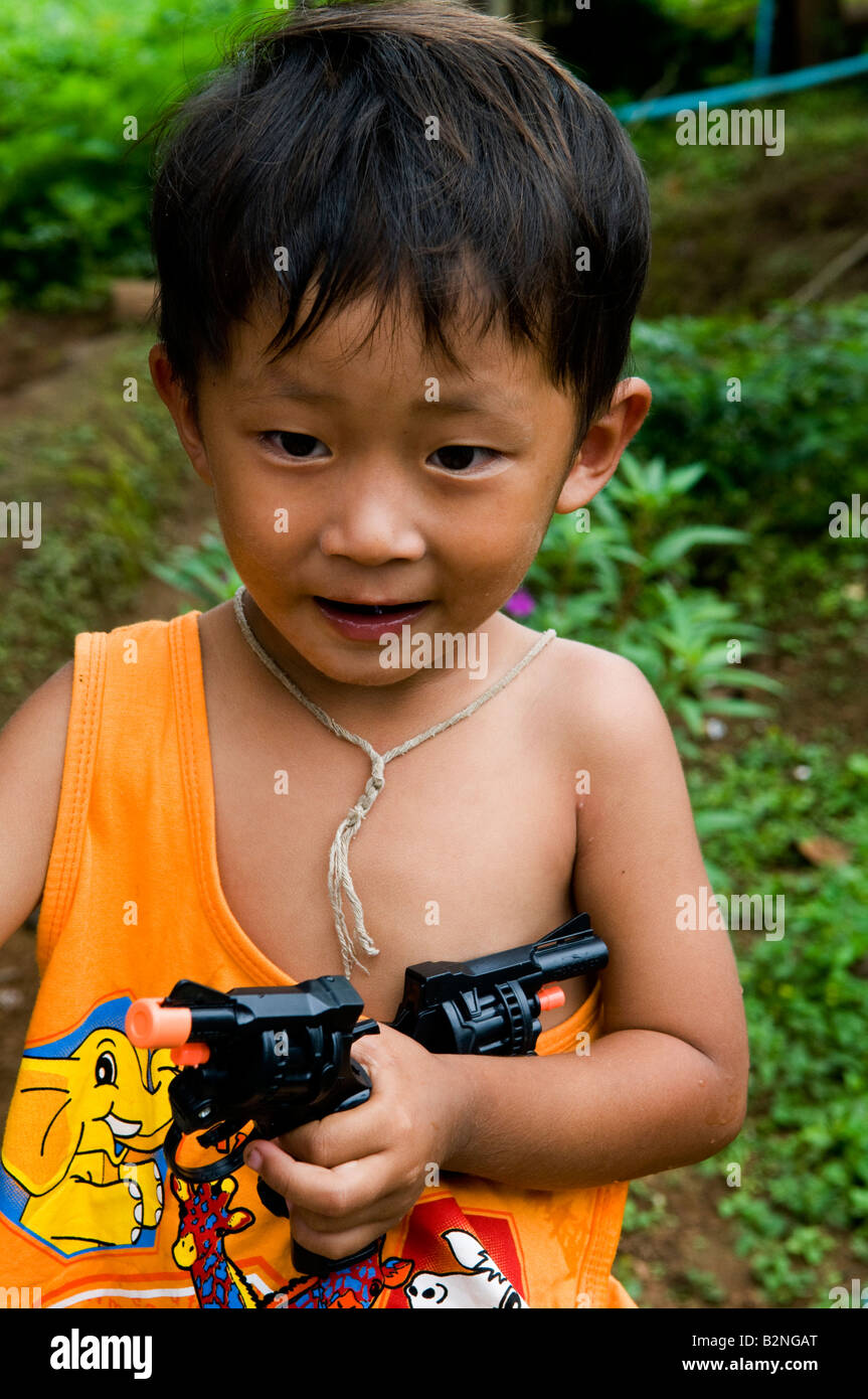 Portrait Of A Cute Thai Boy Holding Two Guns Portrait Of A Cute Thai Boy Holding Two Guns