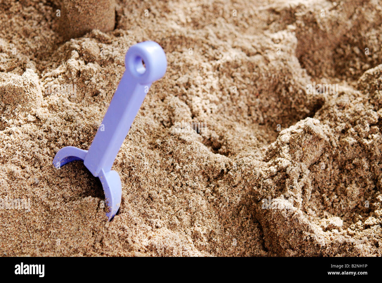 Plastic toy shovel in sandbox Stock Photo