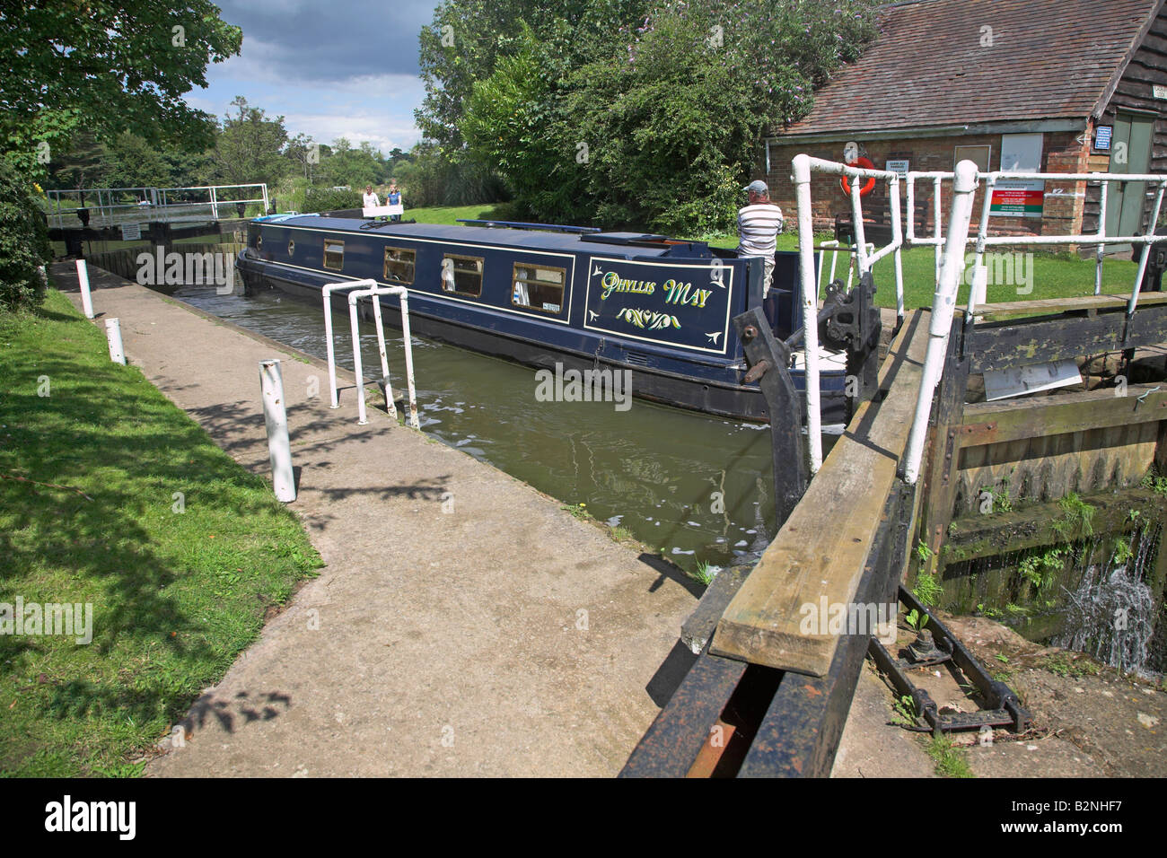Navigating narrow boat through a lock River Avon, Fladbury