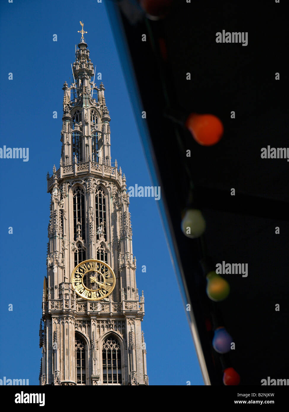 Antwerp cathedral belltower with party lights vertical blue sky Stock Photo