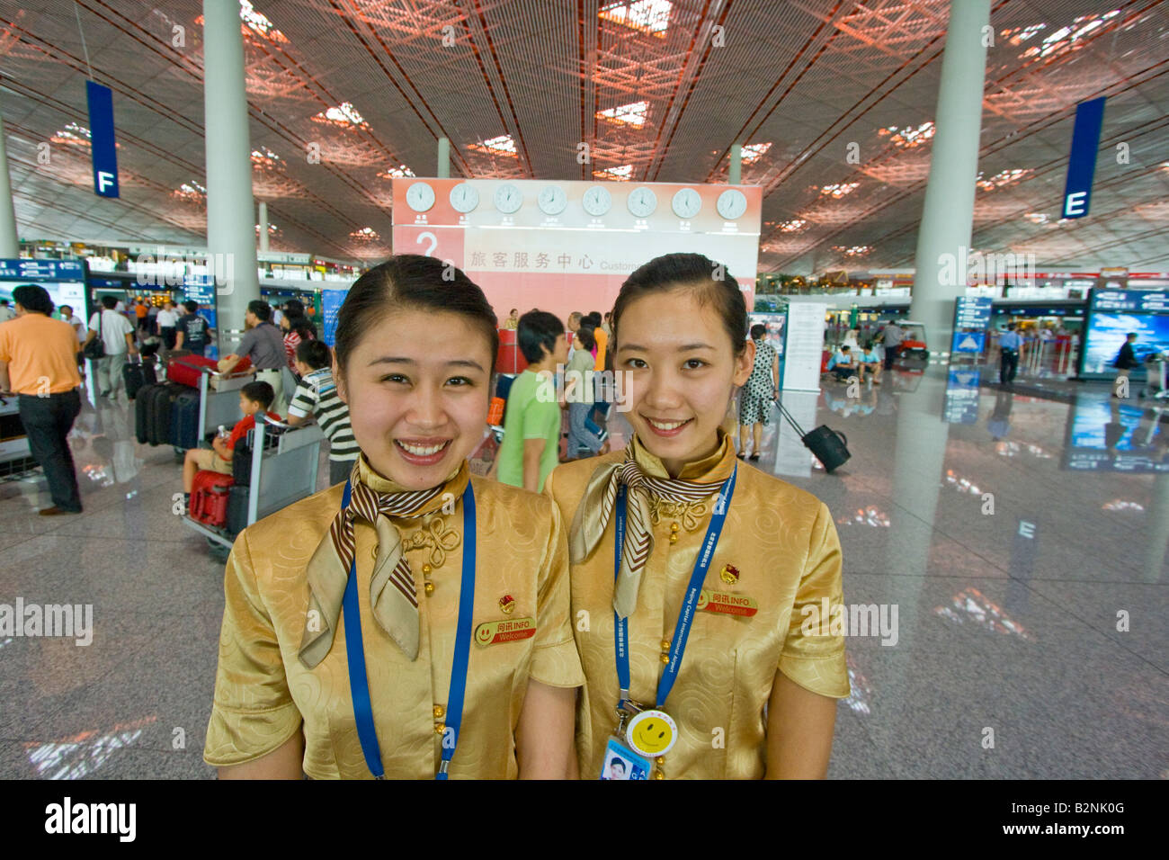 Two Young Airport Information Booth Employees at Beijing International Airport Stock Photo