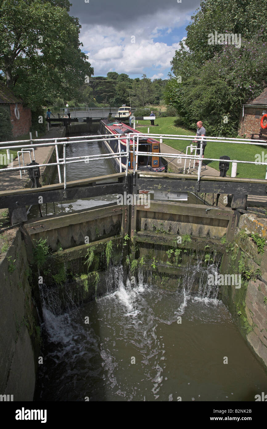 Navigating narrow boat through a lock River Avon, Fladbury
