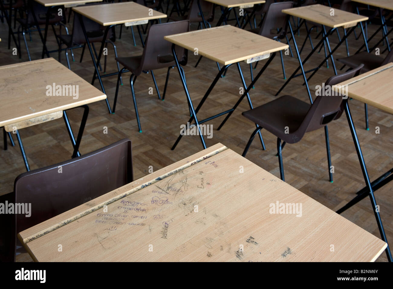 A childs graffiti on a desk used for examinations in a school Stock
