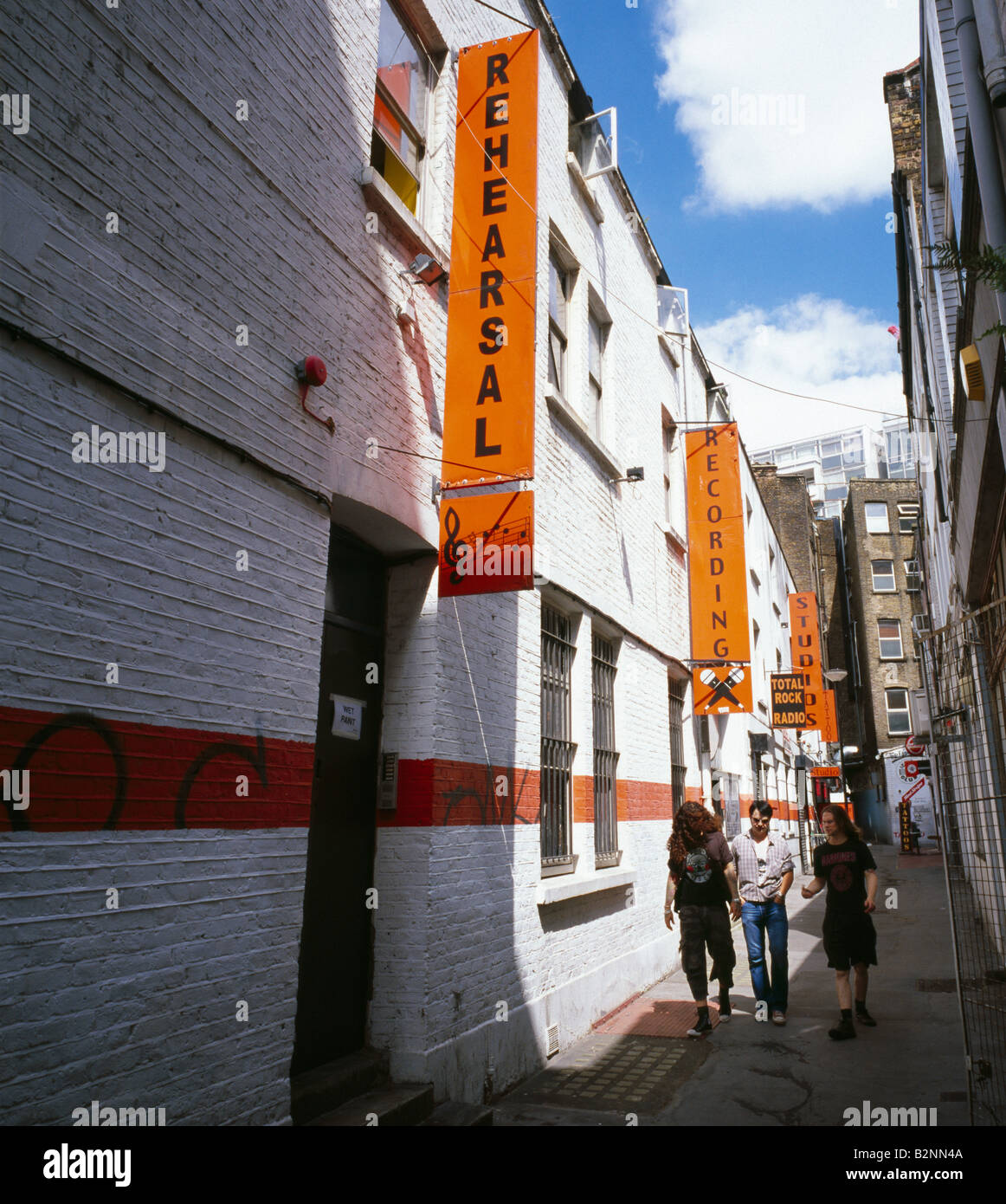 Three young men walking out of Enterprise recording studios. Enterprise House, Denmark Place, London, England, UK. Stock Photo