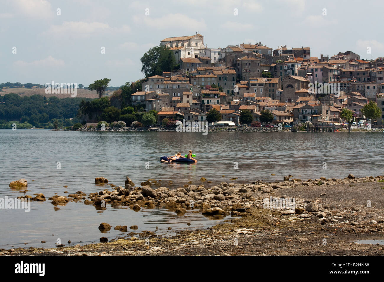 A view of Anguillara by the Bracciano Lake, with a couple of kids playing in the water, in Central Italy Stock Photo