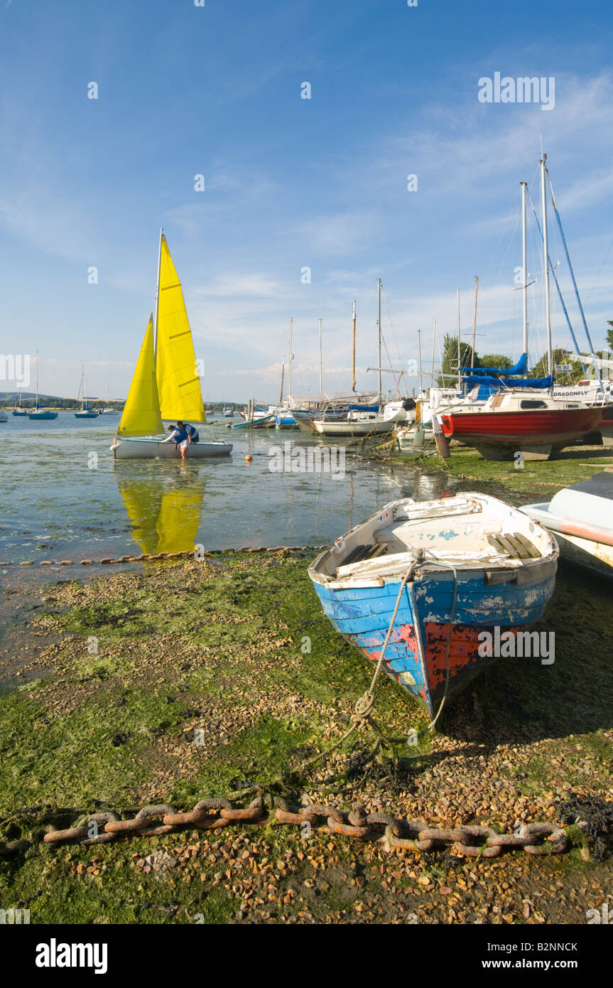 Boat with Yellow sails at Dell Quay, West Sussex, UK Stock Photo