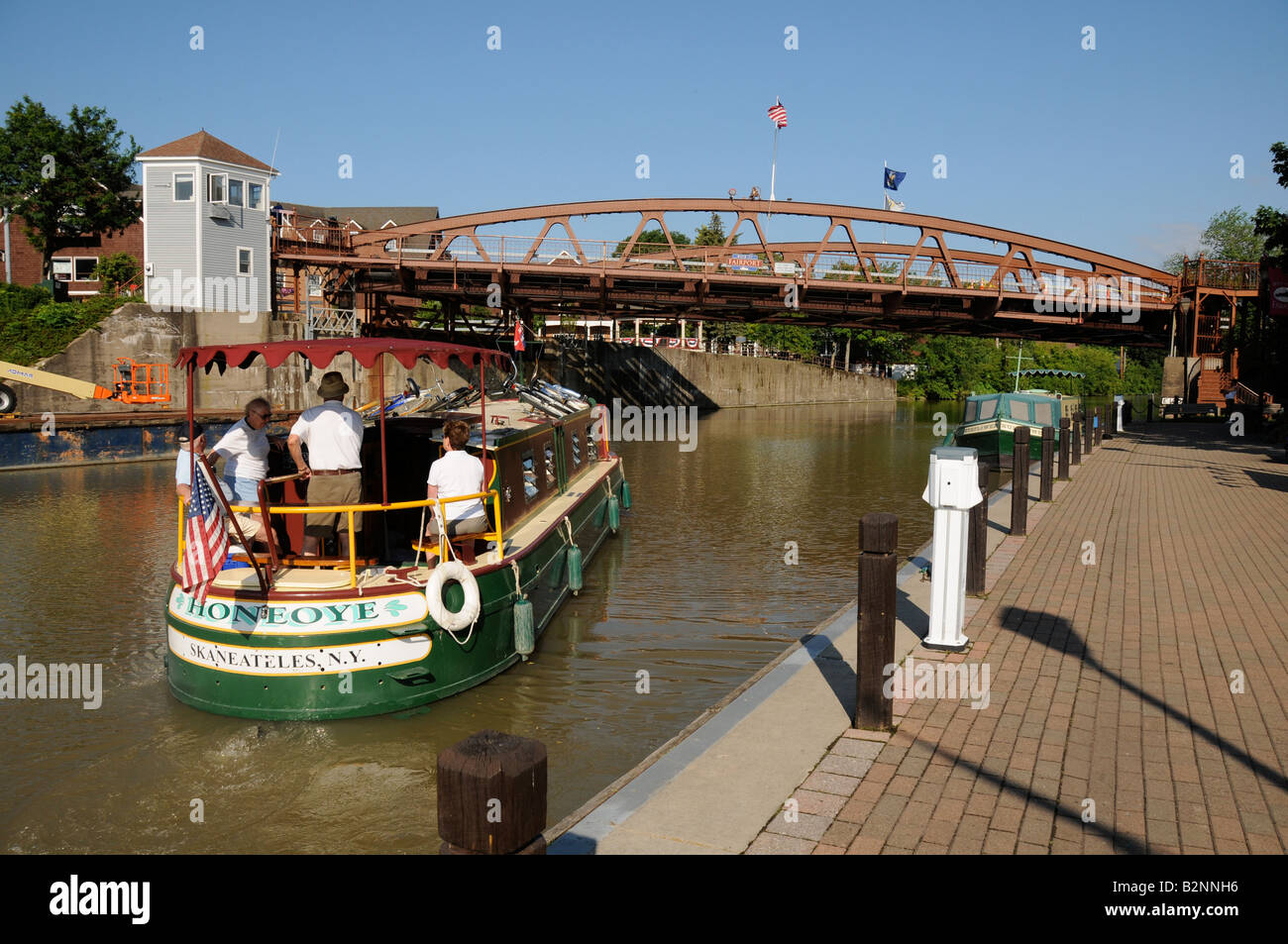 Rented houseboat cruising down the historic Erie Canal in Fairport, NY USA. Stock Photo