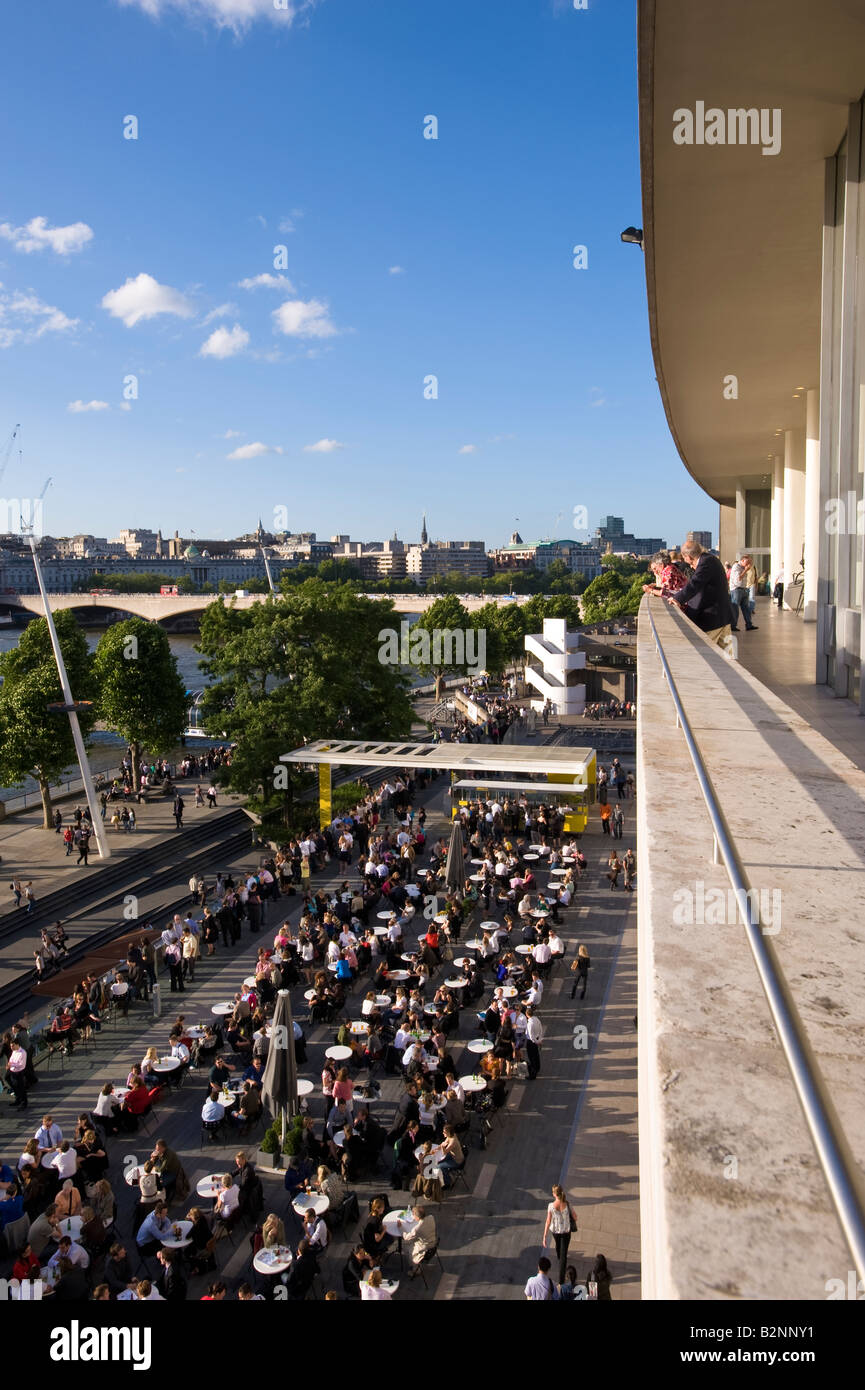 People relax and enjoy a drink on a terrace by Royal Festival Hall Southbank SE1 London United Kingdom Stock Photo