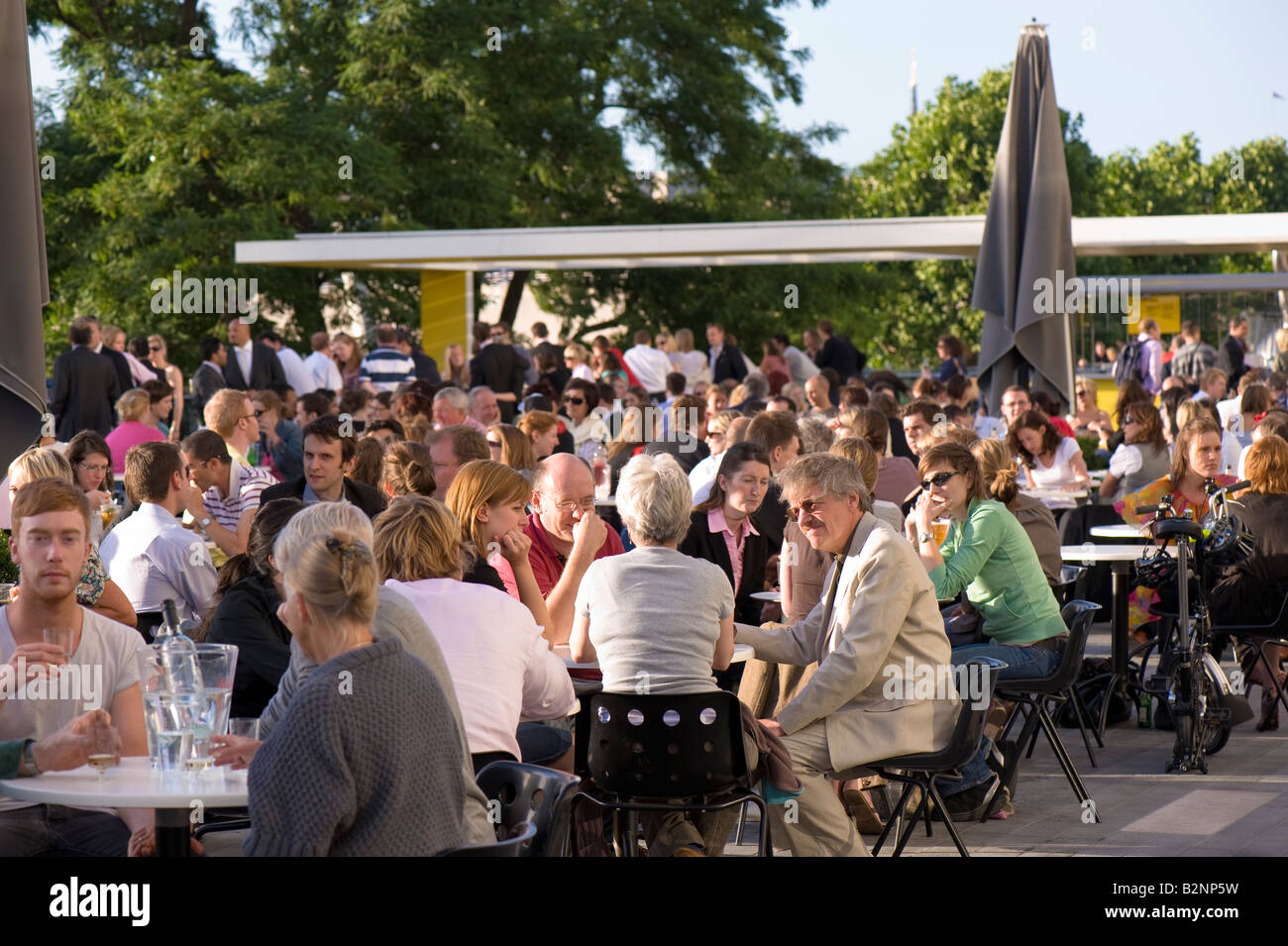People relax and enjoy a drink on a terrace by Royal Festival Hall ...