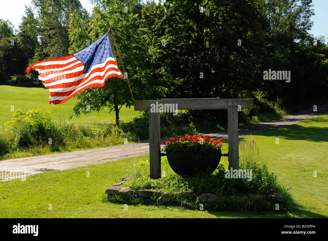 The Stars and Stripes proudly fly at gate to a ranch in upstate, NY. Stock Photo
