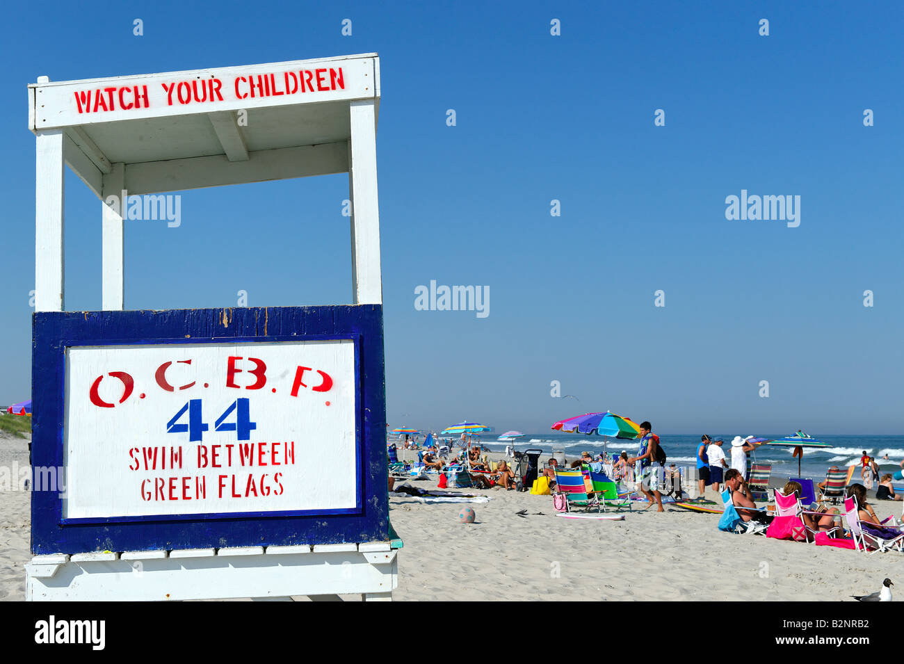 Lifeguard stand and crowded beach Stock Photo