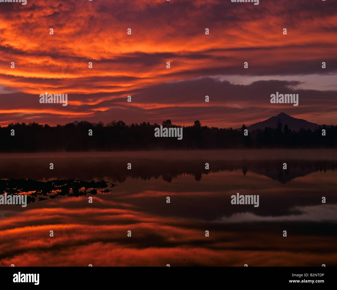 Sunrise at Lake Cassidy with dramatic clouds and Mount Pilchuck