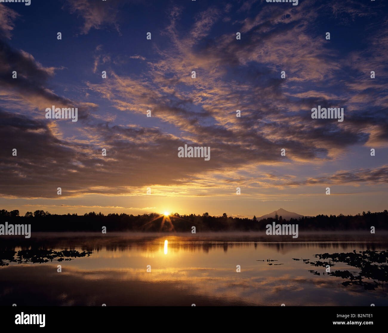 Sunrise at Lake Cassidy with dramatic clouds and Mount Pilchuck