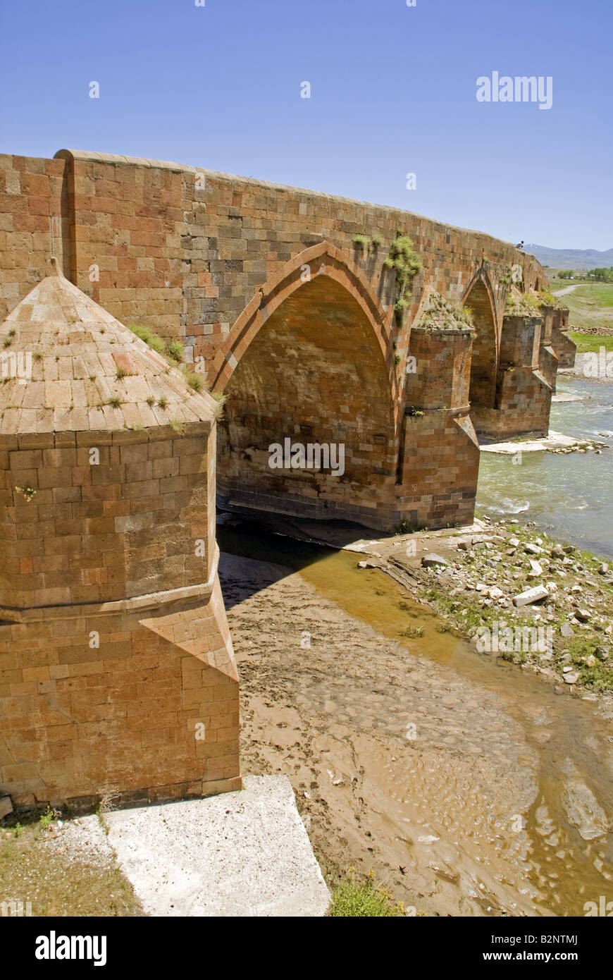13th Century Ottoman Cobandede Bridge over Aras River between Pasinler and Horasan Stock Photo