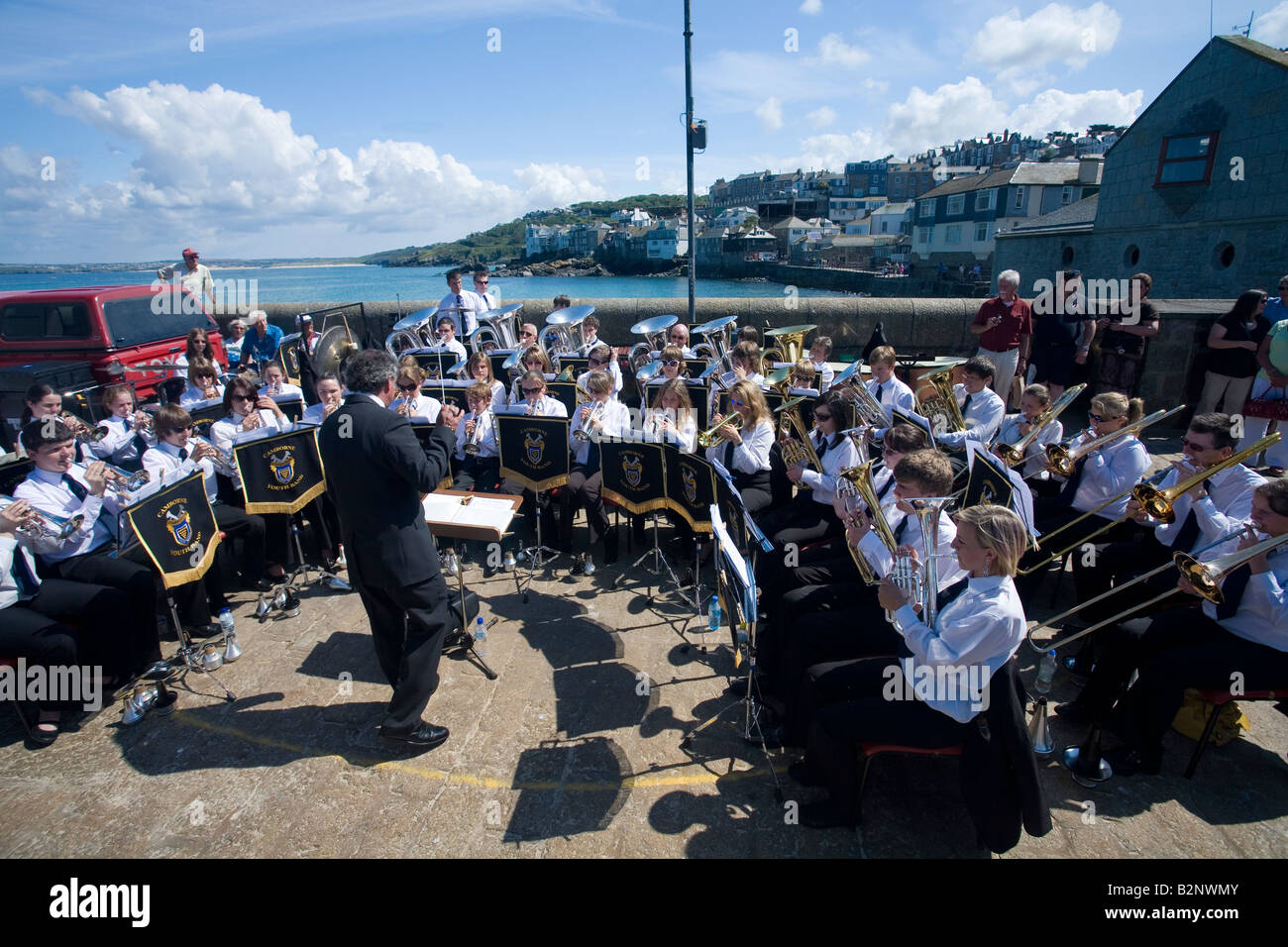 Camborne Youth Brass Band play outdoors concert in open air at the harbour harbor St Ives Cornwall England UK United Kingdom GB Stock Photo