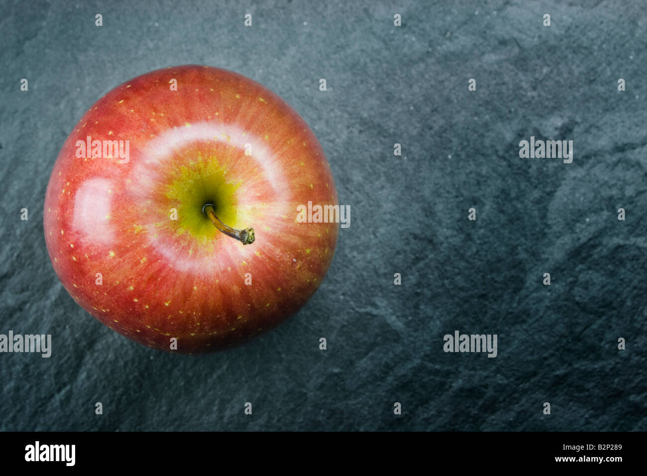 A red delicious apple on grey background Stock Photo Alamy