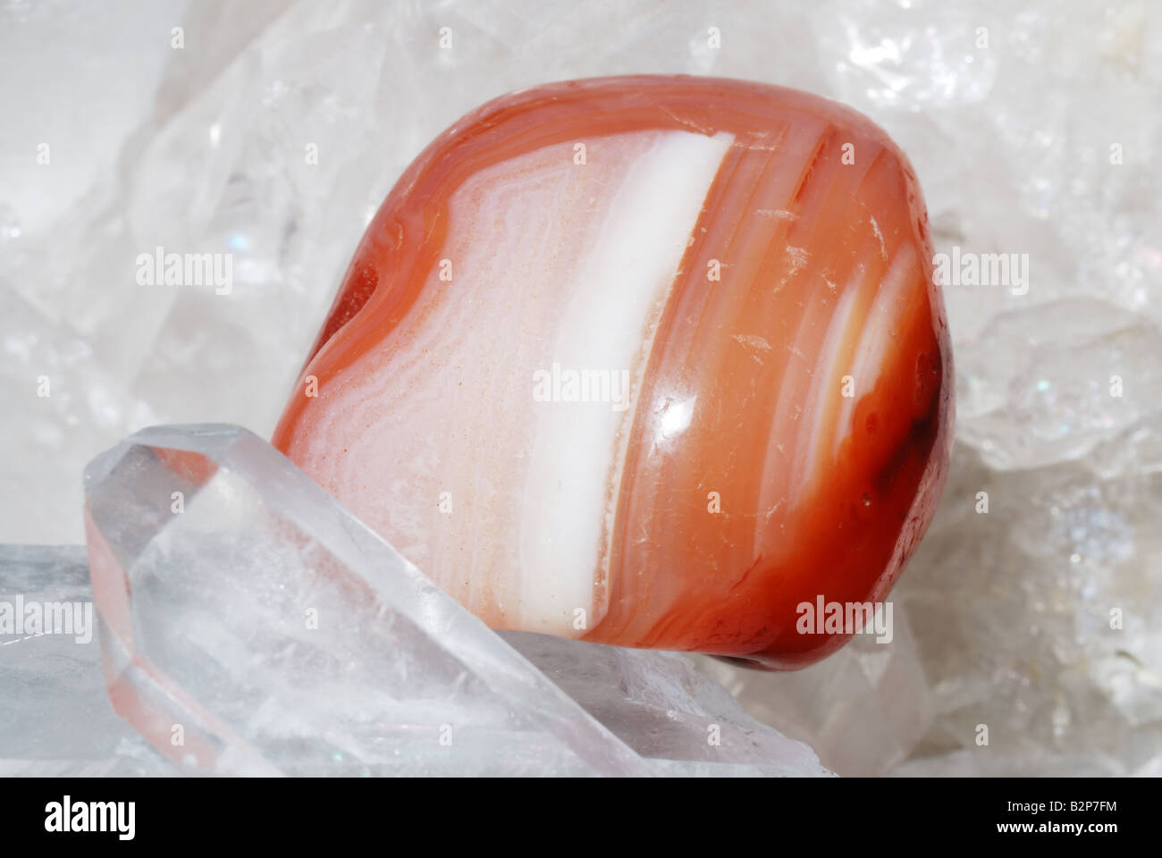 Orange carneol gem energized on druze of quartz crystals Stock Photo