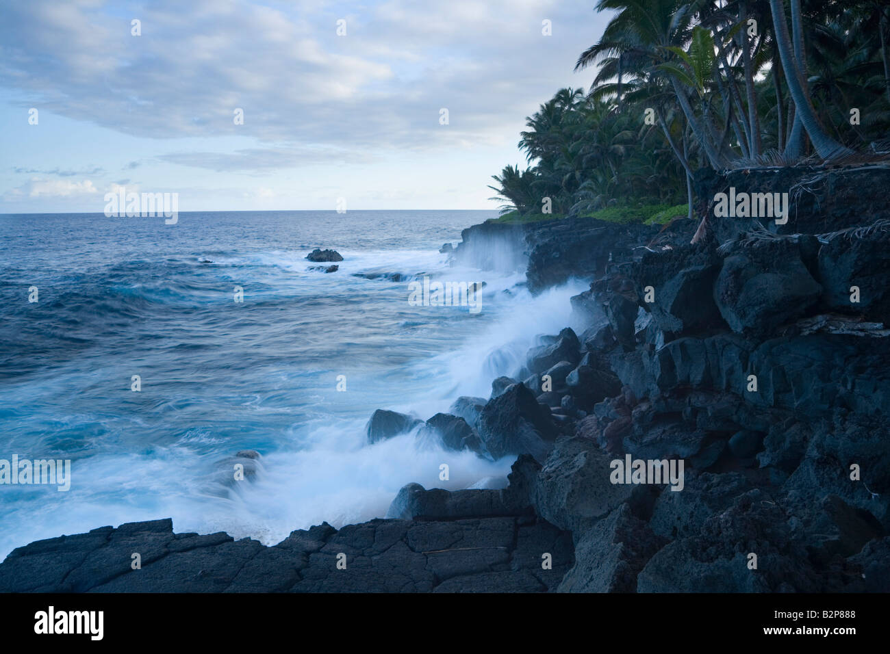 Waves beating black volcanic rock on the Puna Coast Big Island Hawaii USA Stock Photo