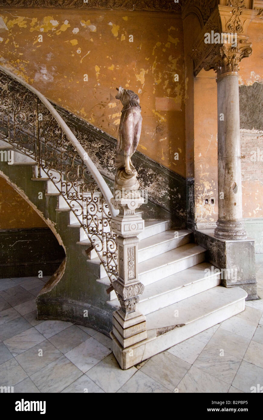 Broken figurine on an old staircase inside run down colonial house used in Cuban film Fresa y Chocolate. Centro, Havana Stock Photo
