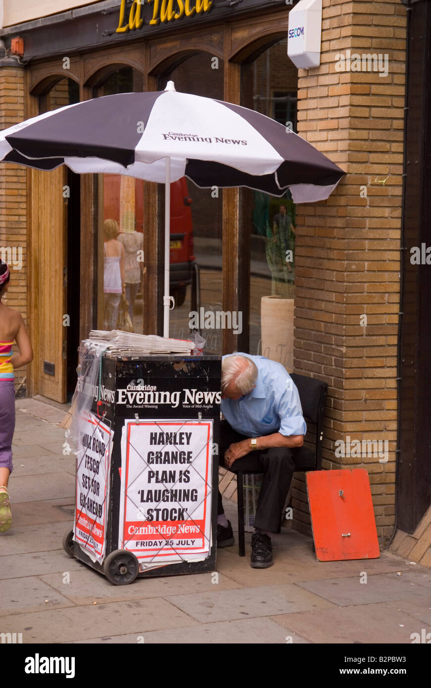 Man selling newspapers in street Stock Photo Alamy