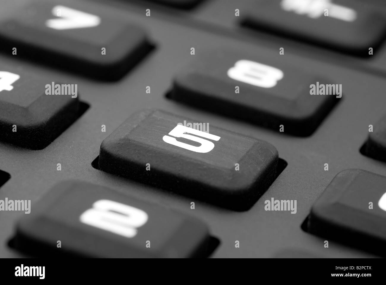 A close up of a rubber keypad of a calculator focused on number 5 Stock Photo