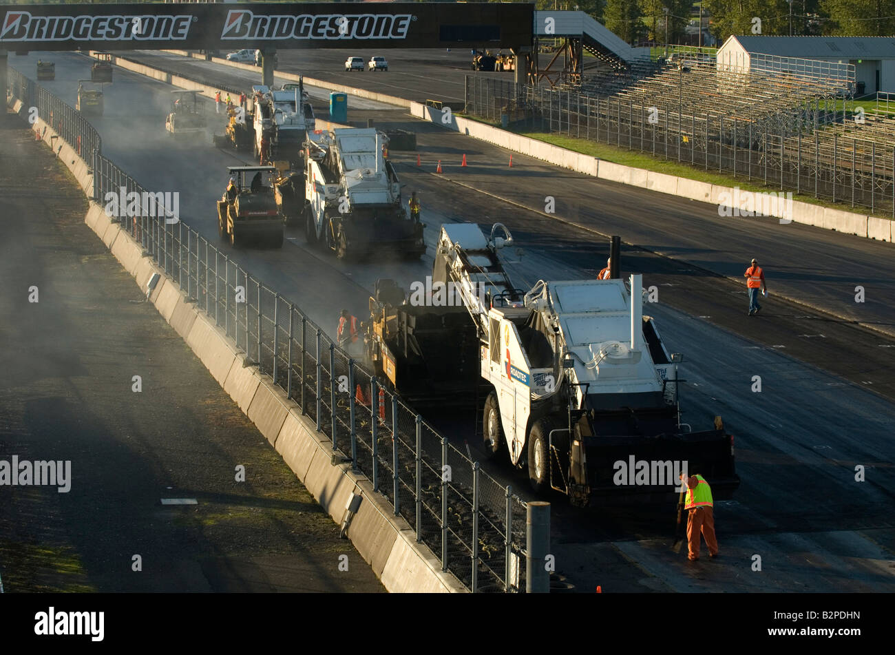 Asphalt paving machines working in echelon formation during the reconstruction of PIR Auto Race Track Stock Photo