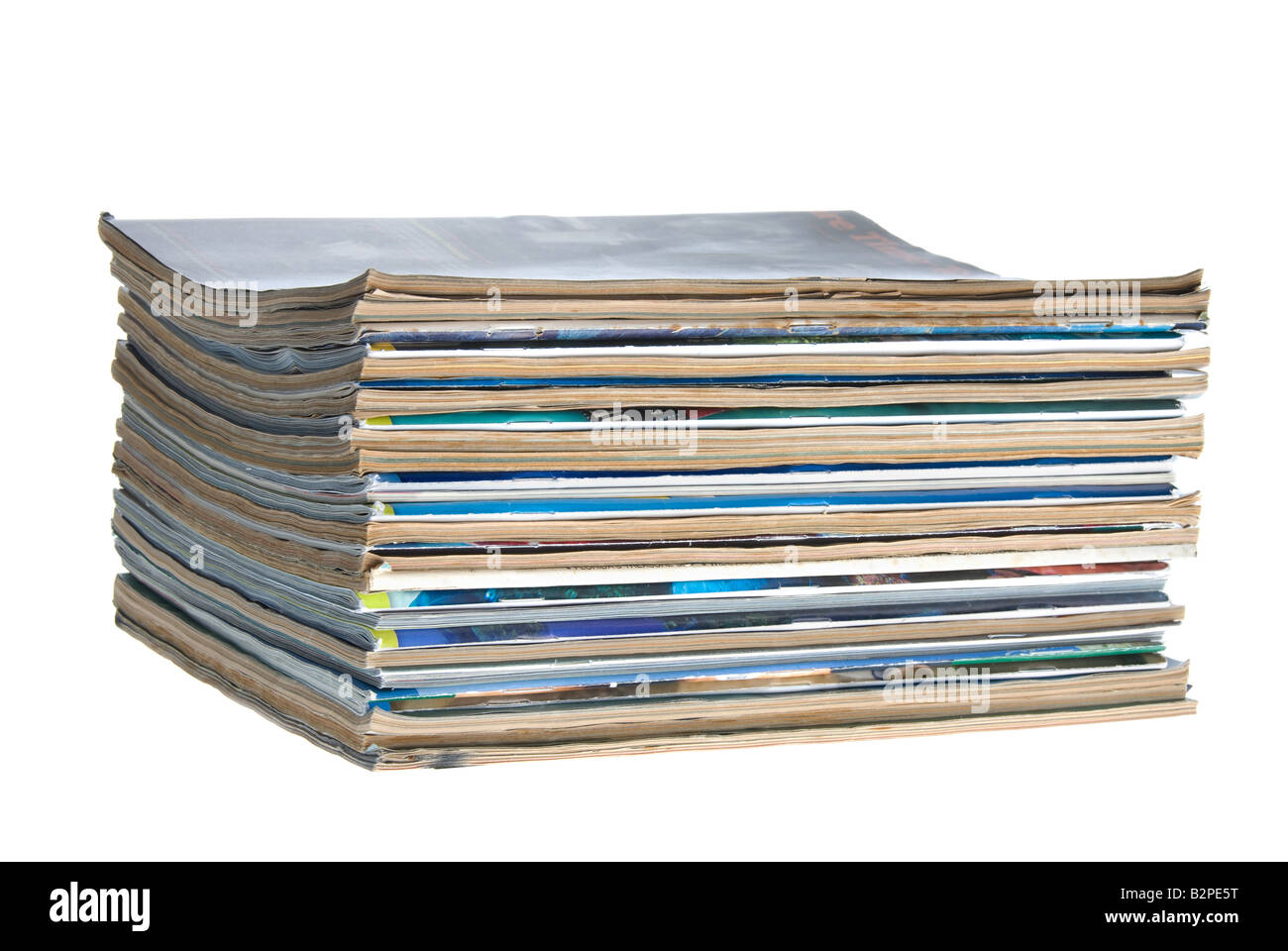 A stack of old worn magazines isolated against a white background Stock Photo