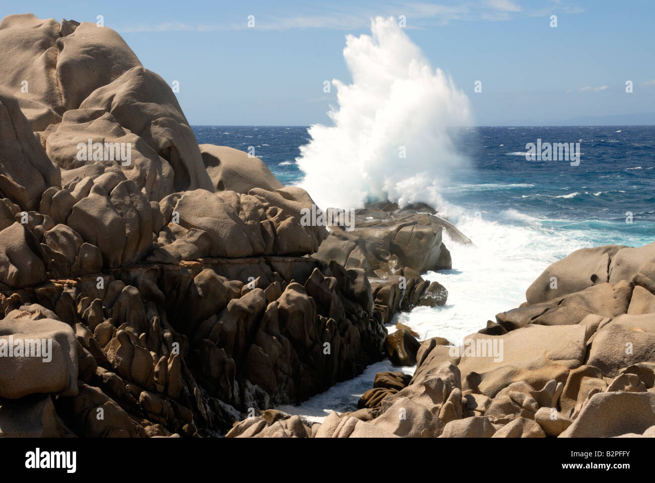 Wave crashing against rocks on the Capo Testa headland of North Sardinia Stock Photo