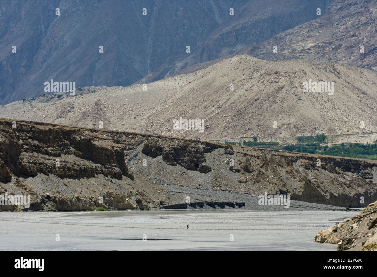 Hunza Man Walking on Suspension Bridge in Passu Northern Pakistan Stock Photo