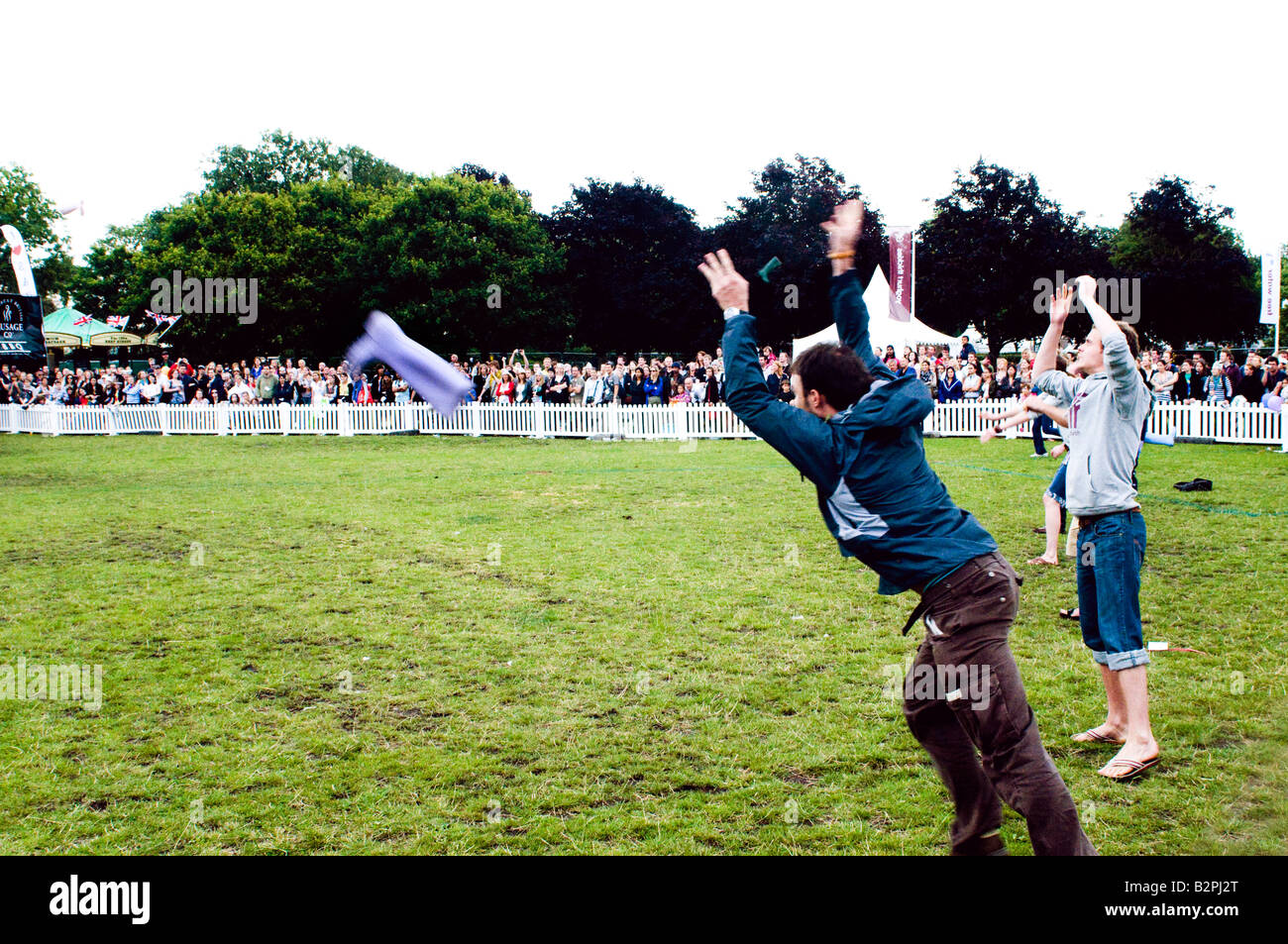 children compete in welly wanging competition at a london summer festival Stock Photo