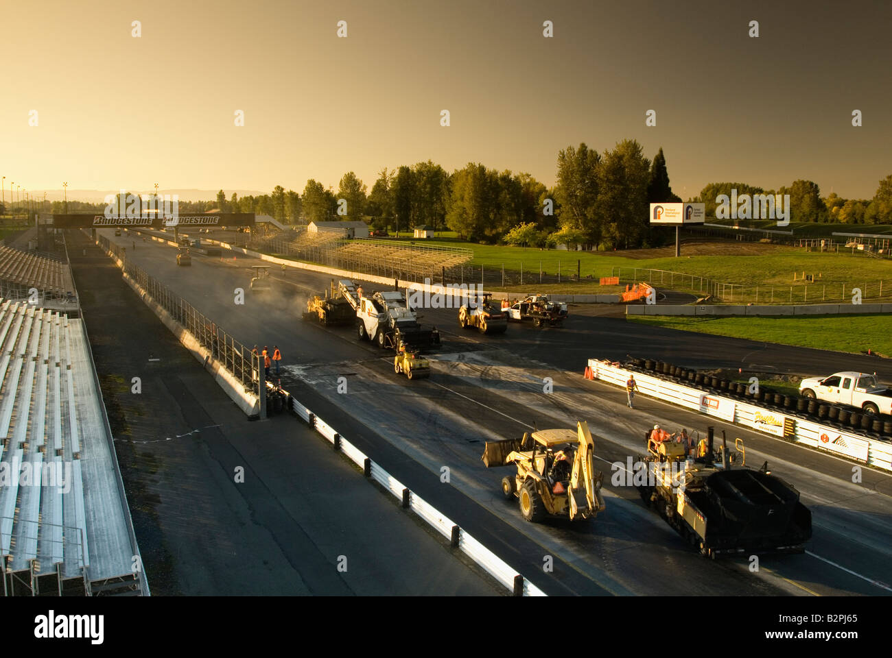 Asphalt paving machines working in echelon formation during the reconstruction of PIR Auto Race Track Stock Photo