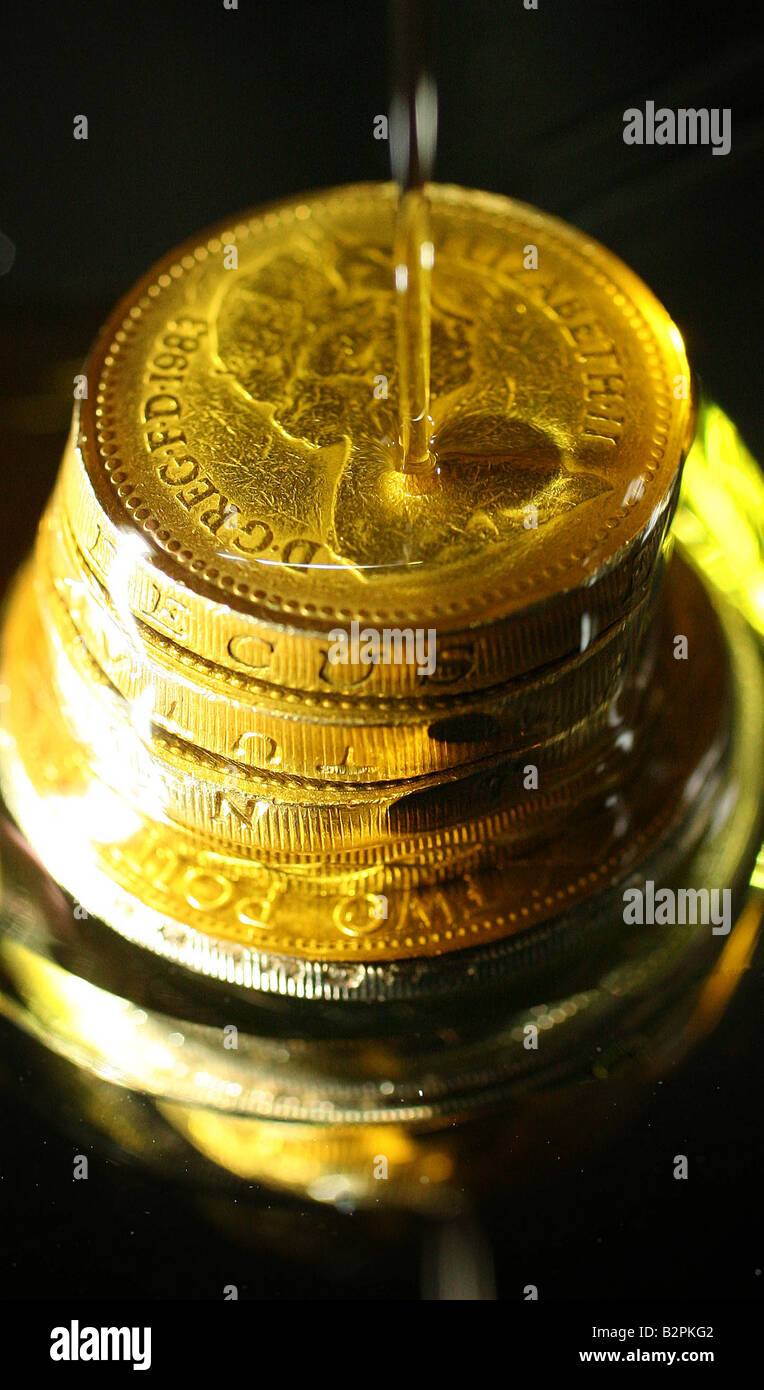British one pound coins are immersed in oil Stock Photo
