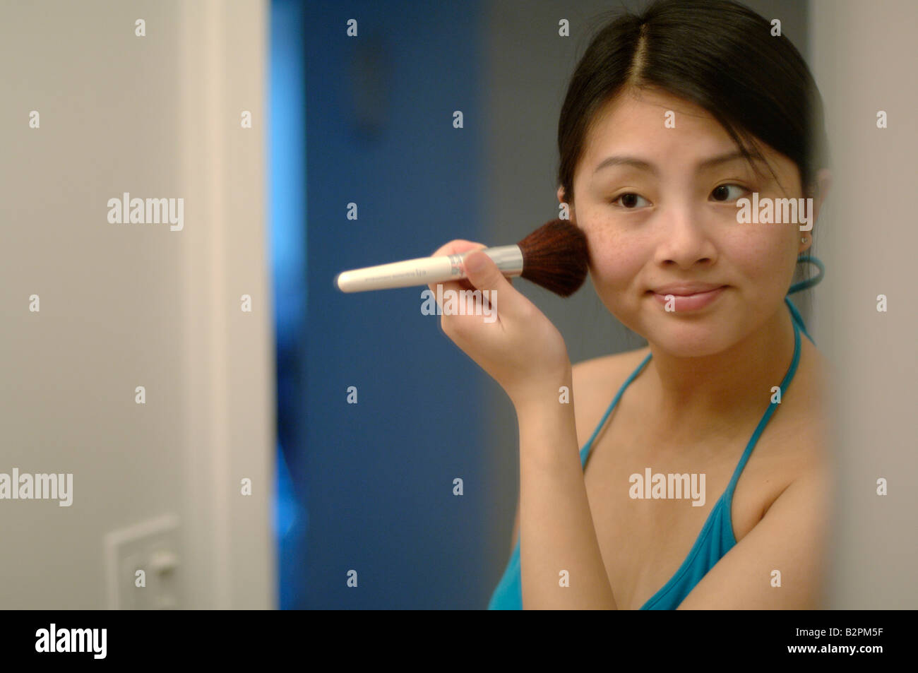 Reflection of Chinese woman applying blush with brush Stock Photo Alamy