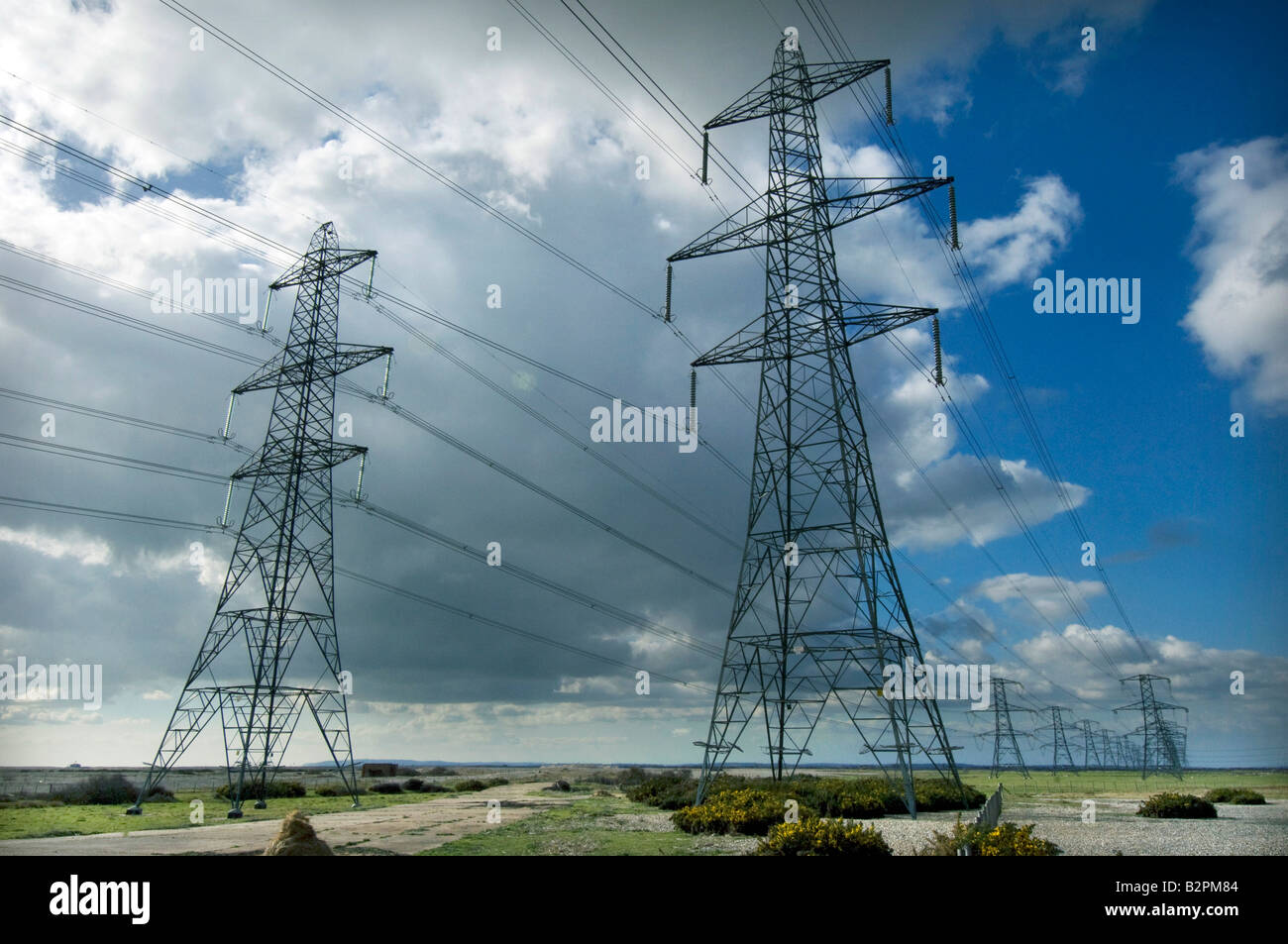 Electricity pylons carrying power from the British Energy Dungeness B Nuclear Power Station across the Kent countryside Stock Photo