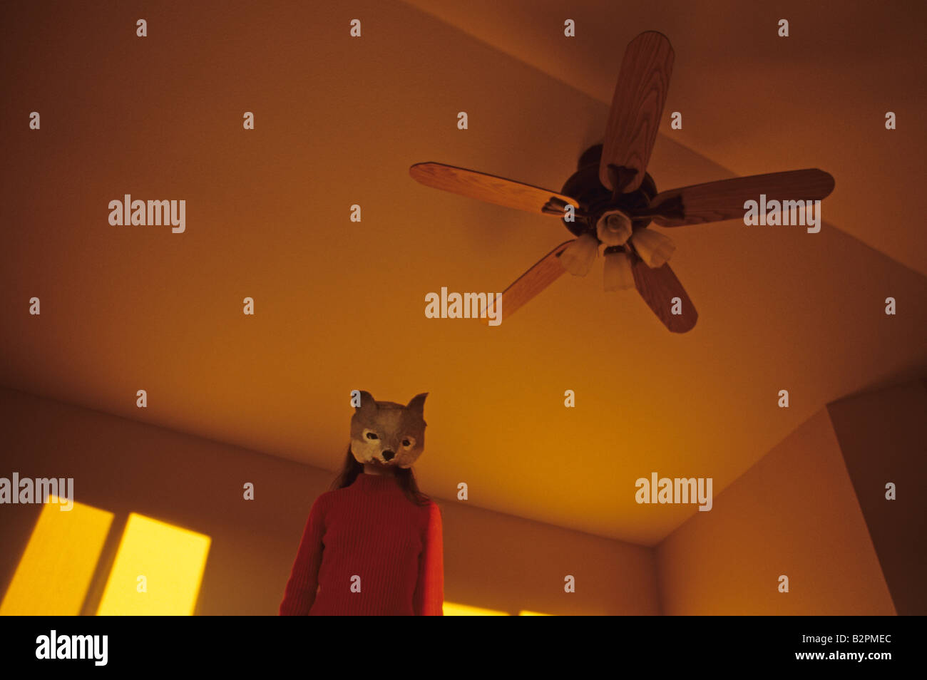 Portrait Of Teen Girl Wearing A Wolf Mask Inside A House