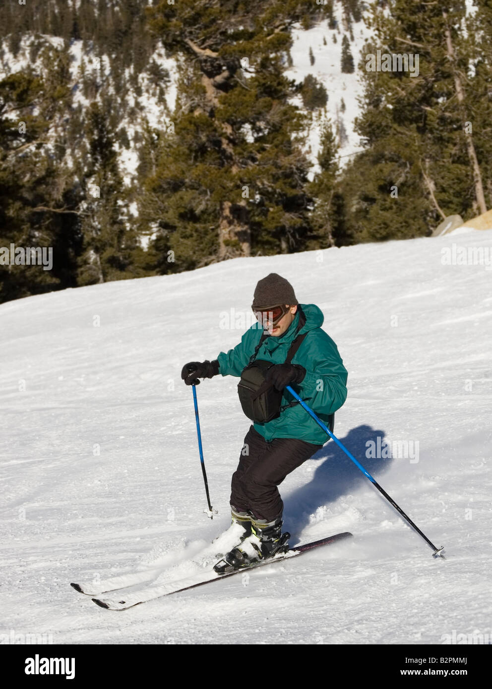 A man with chest pack skiing downhill at lake Tahoe resort Sierra