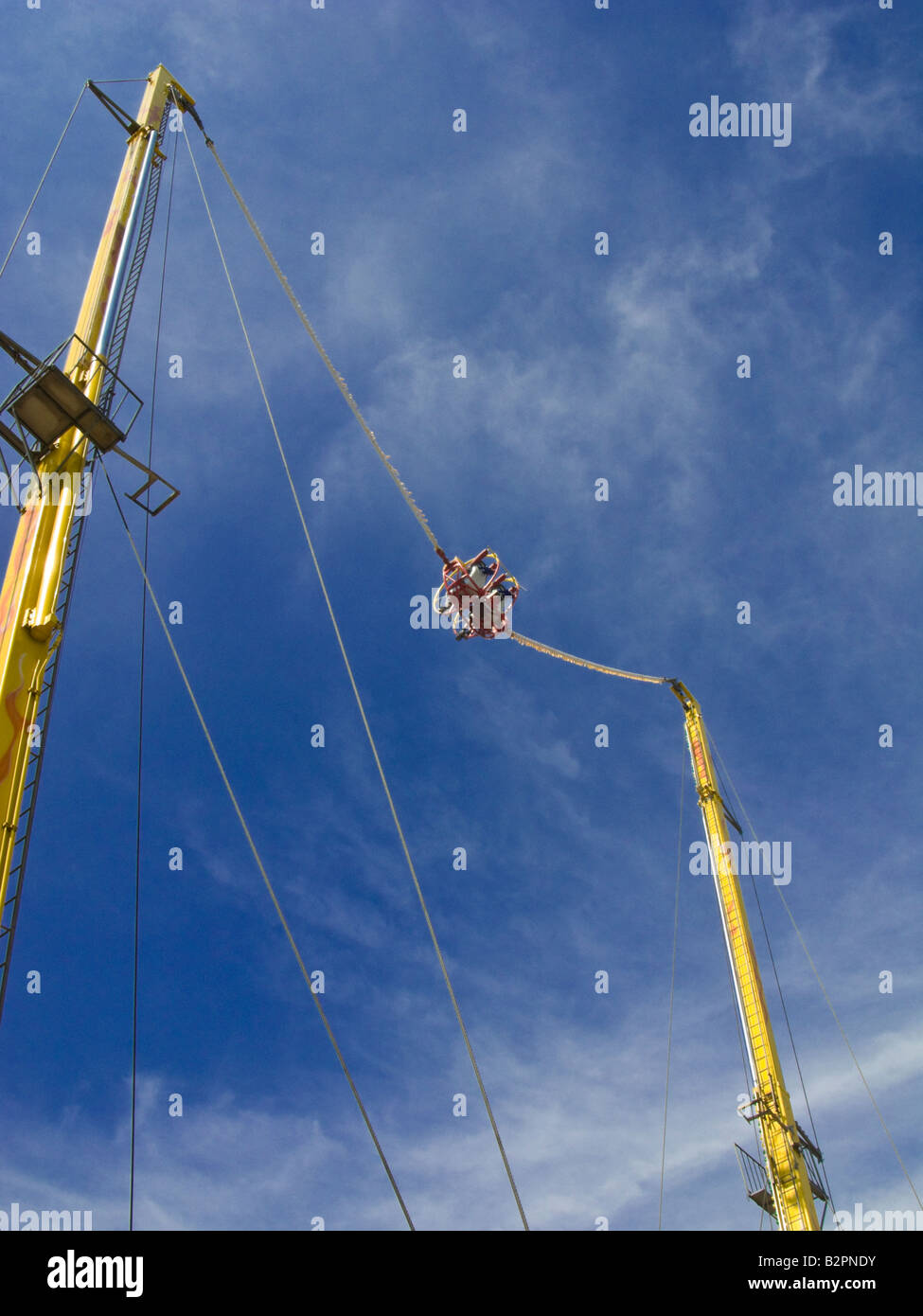 Reverse Bungee fairground ride against a blue sky Stock Photo Alamy