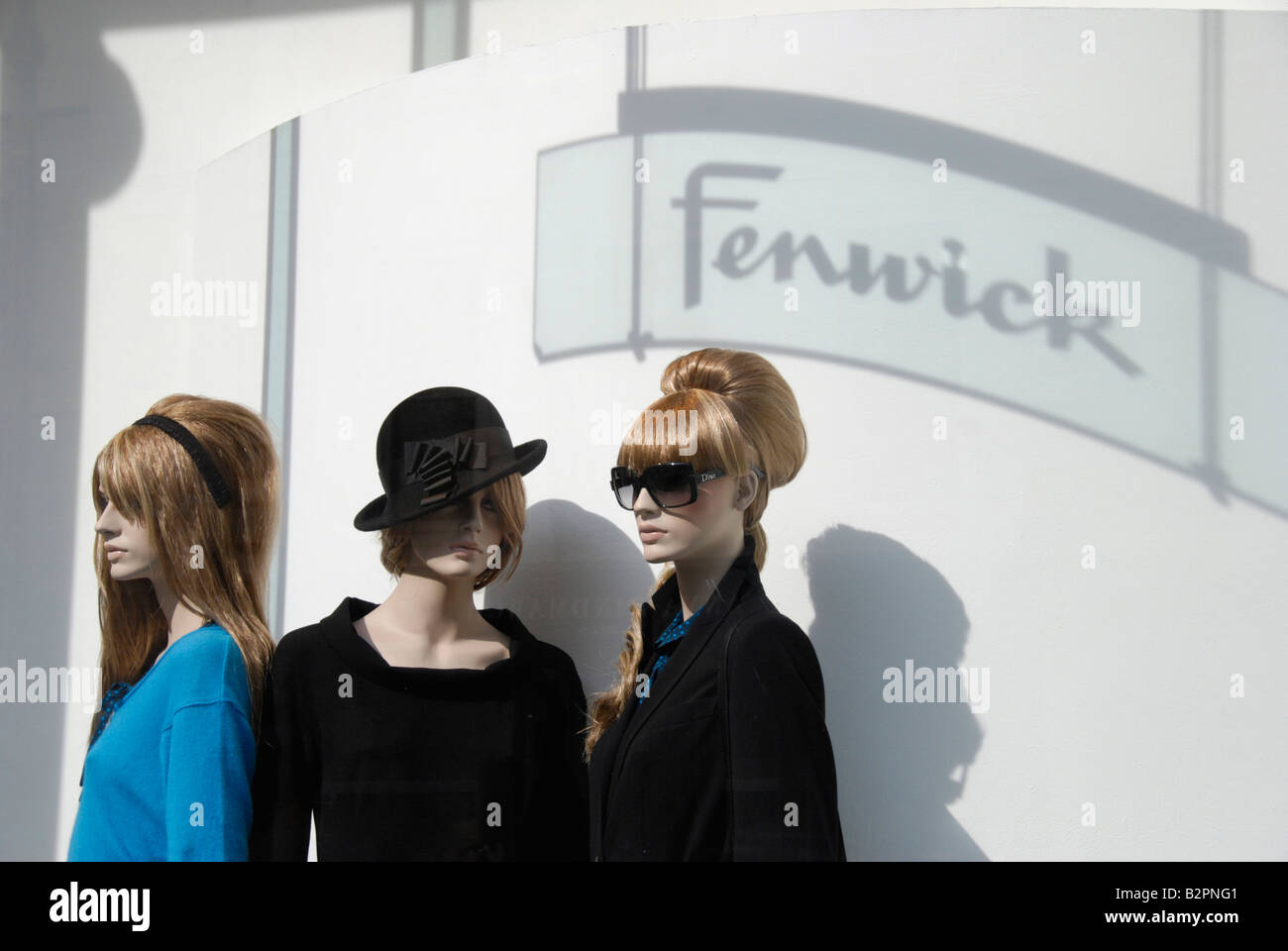 Three female mannequins in on display in Fenwick department store window New Bond Street London England Stock Photo