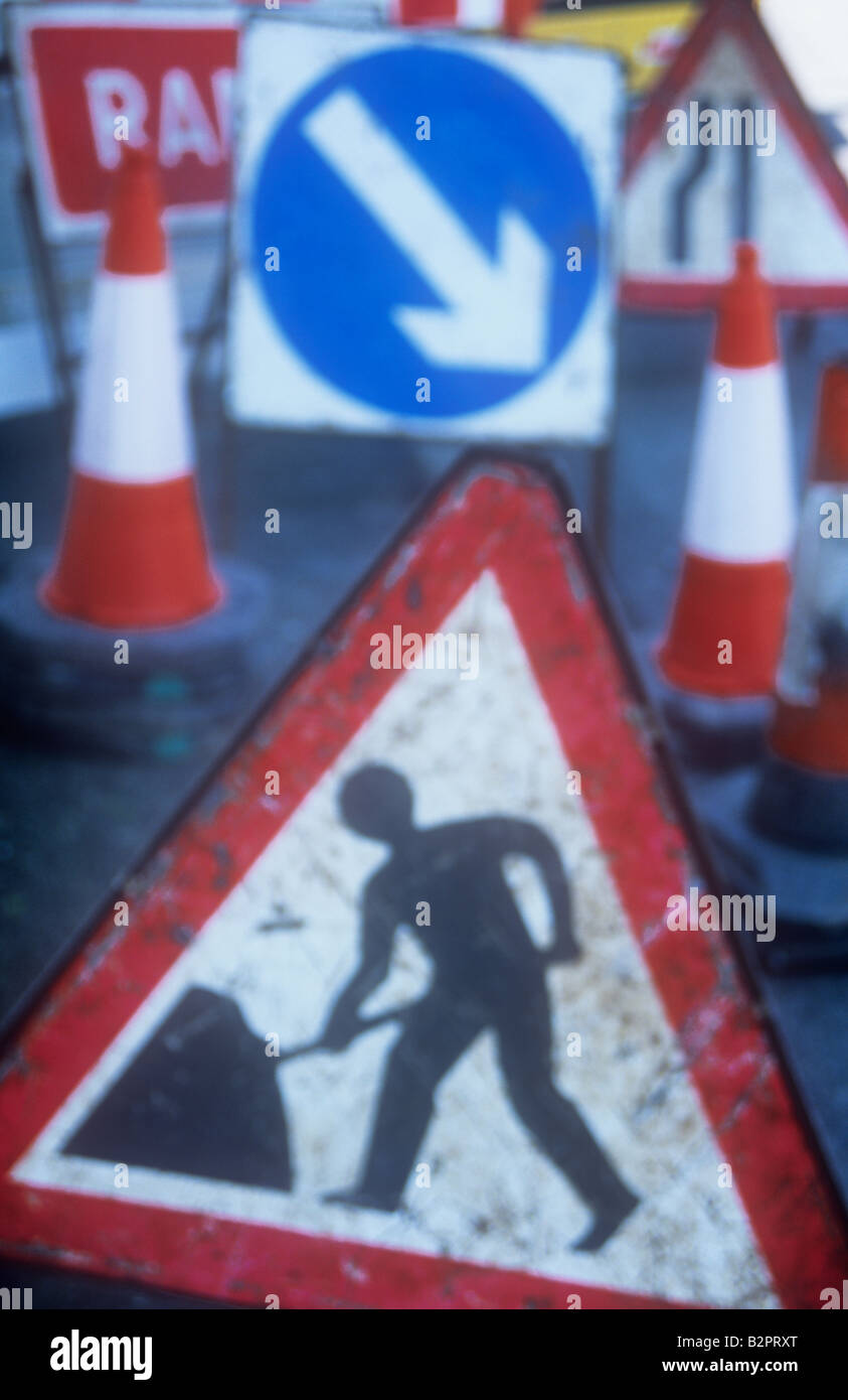 Impressionistic assemblage of well-used roadworks signs including Roadworker Cones Keep right Road narrows and Ramp Stock Photo